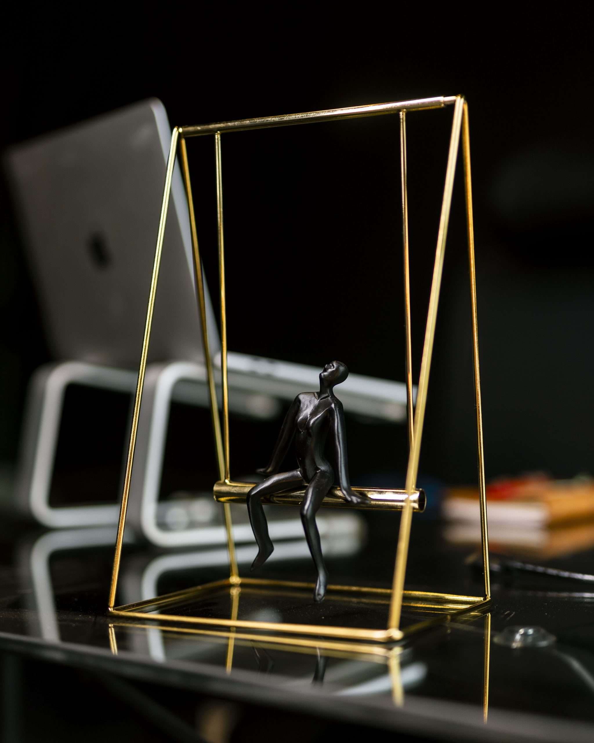 Brass swing sculpture on a desk in the Daily360 Creative studio